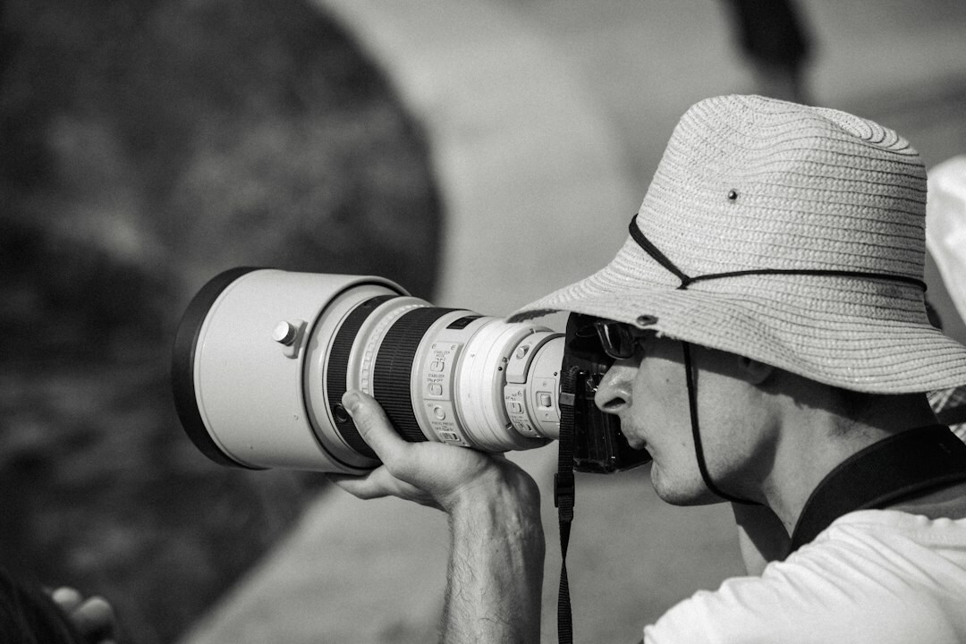 Professional photographer with a telephoto lens photographing an event